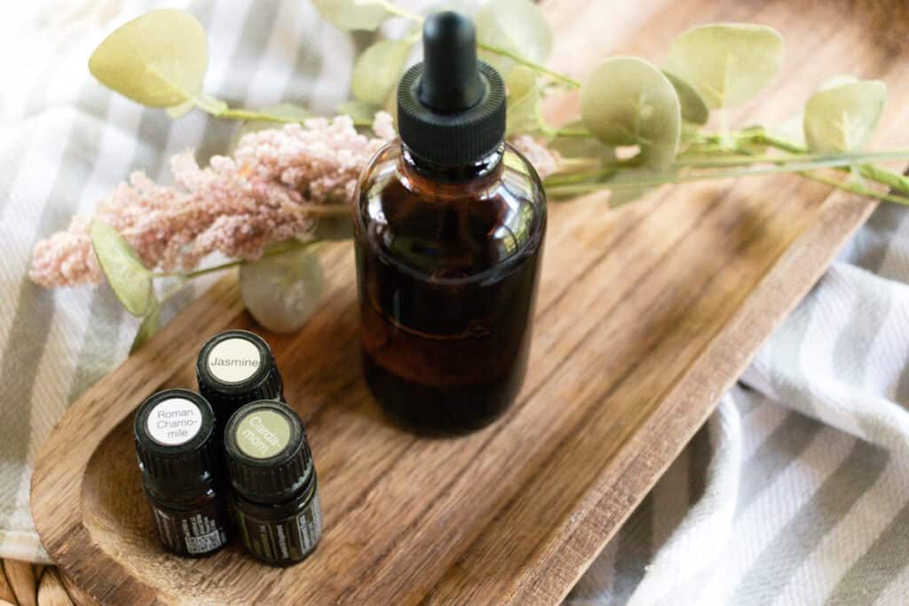Massage oil in a glass dropper bottle on the side of the bed.
