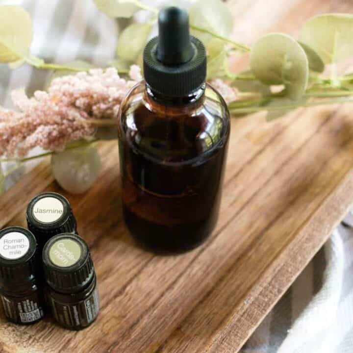 Massage oil in a glass dropper bottle on the side of the bed.