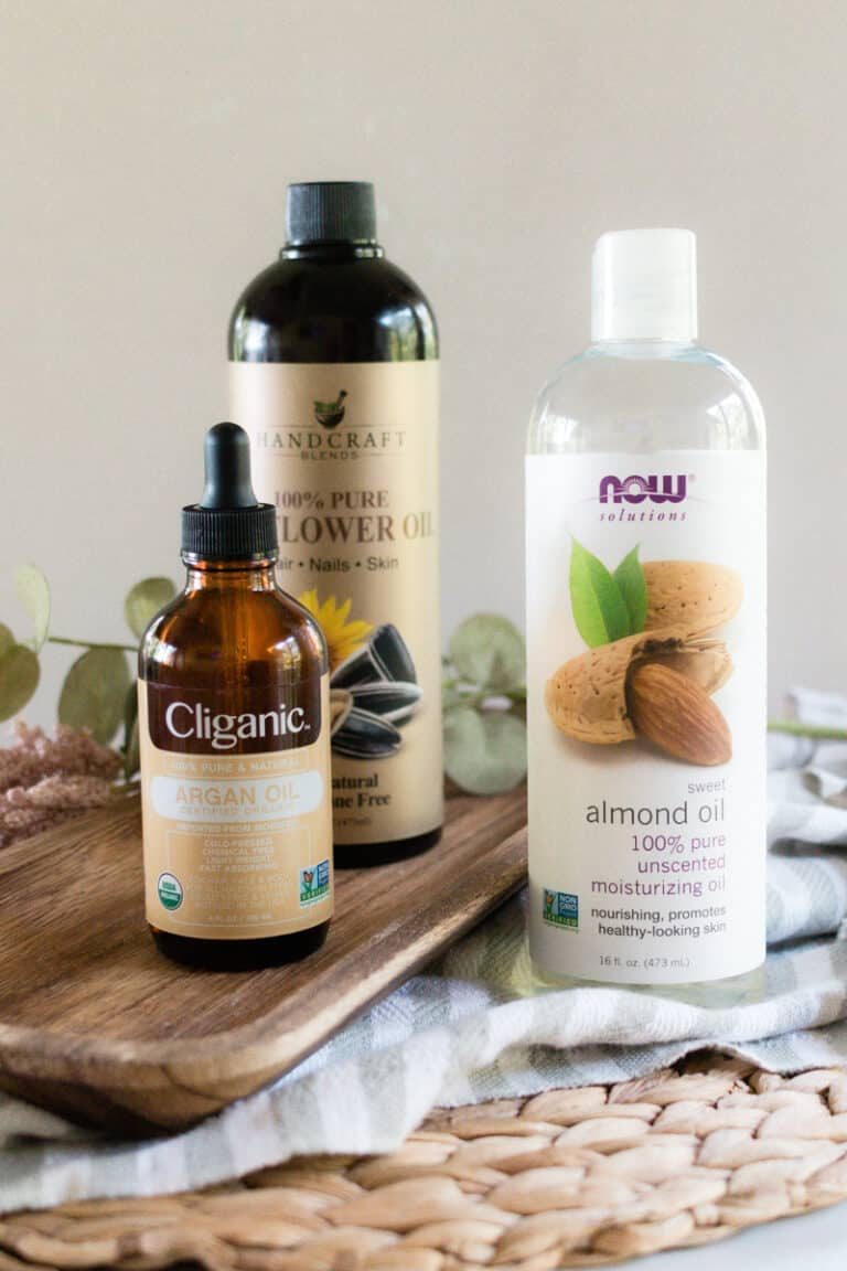 Ingredients to make DIY massage oil on a wooden board.