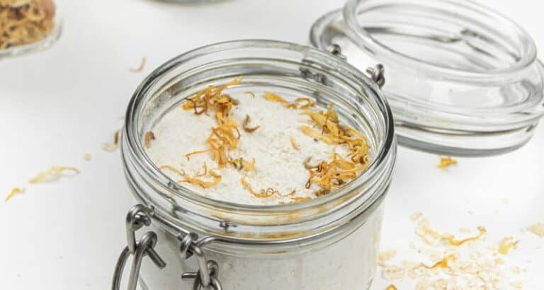 Oatmeal milk bath with dried flowers in mason jars.
