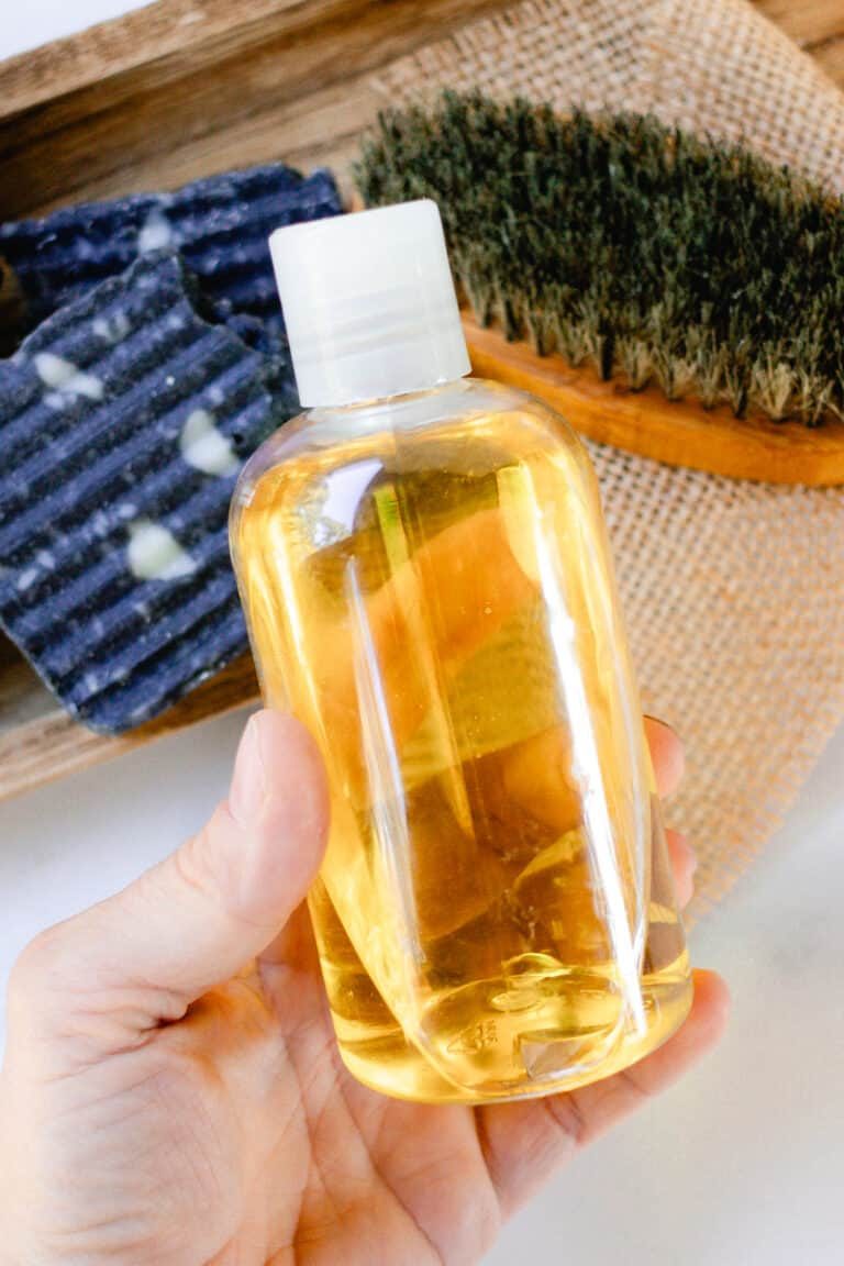 Holding a bottle of pre shave oil in our hands.