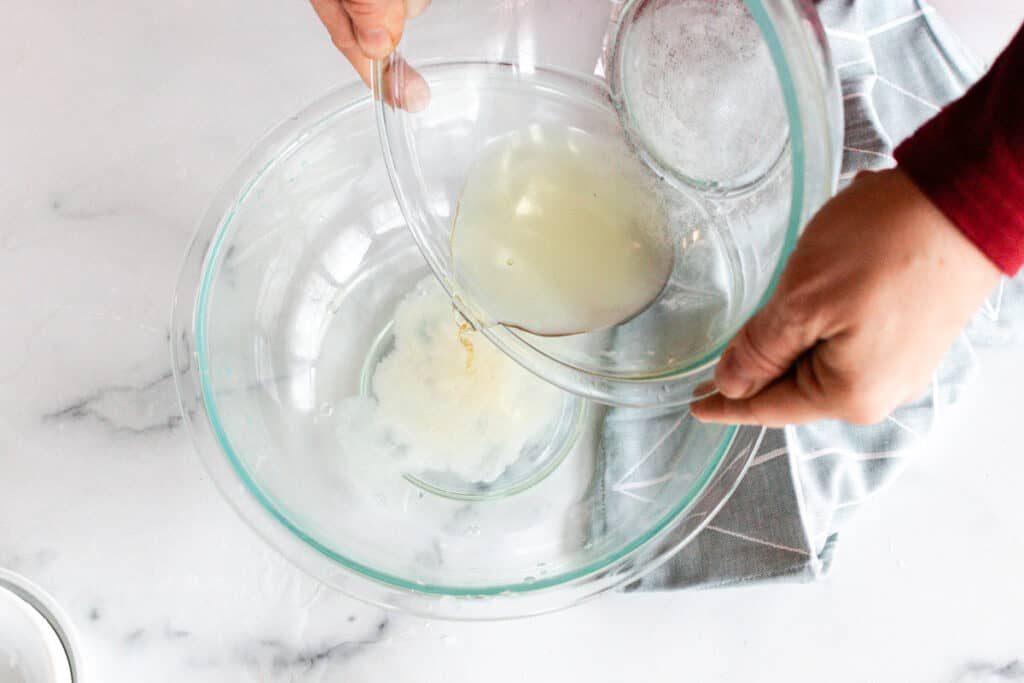 Pouring the melted oils into the water.
