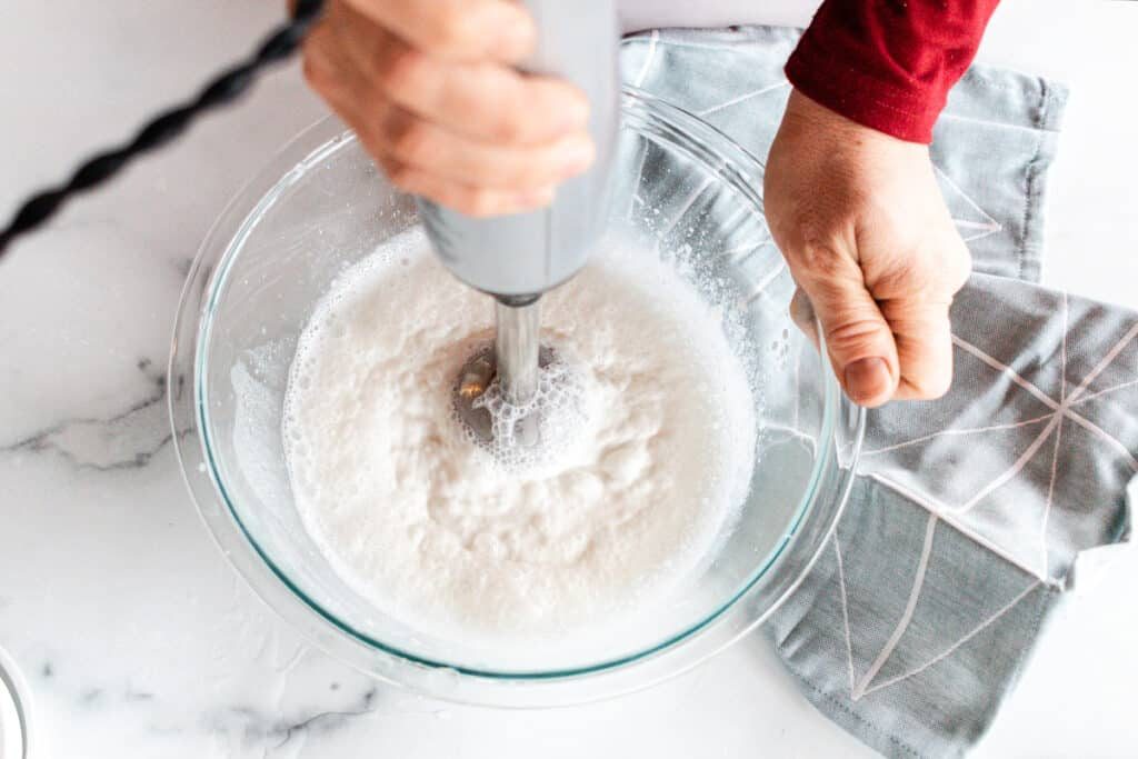 Emulsifying the pumpable lotion ingredients with an immersion blender.
