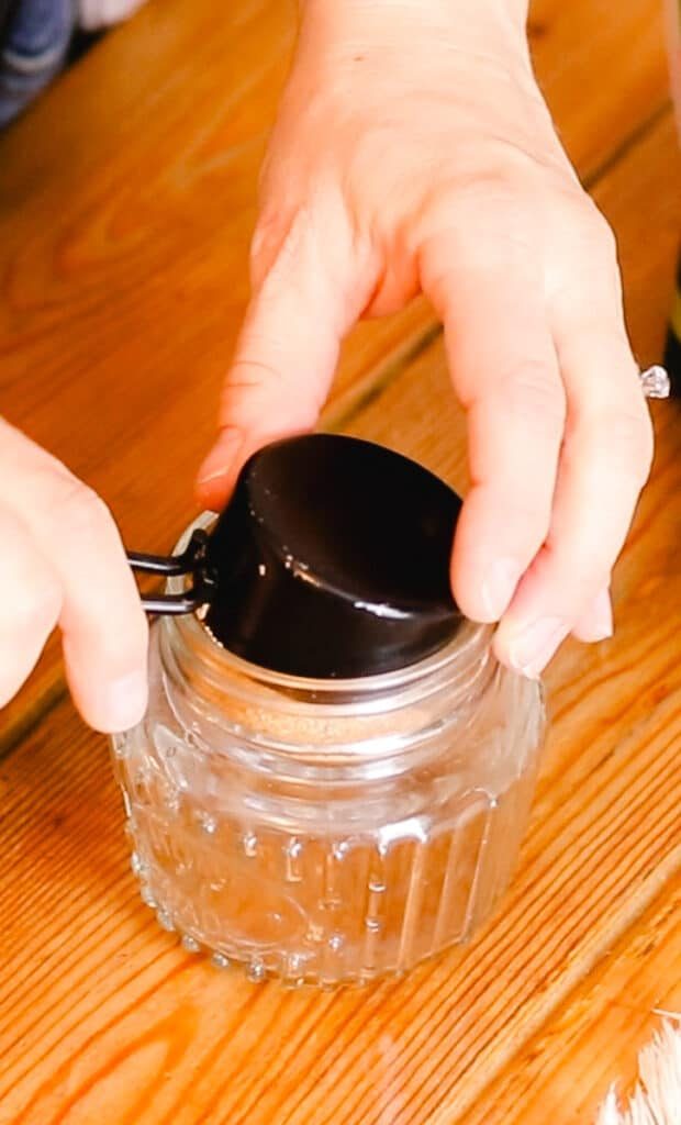 Measuring out the brown sugar and adding it to the jar.