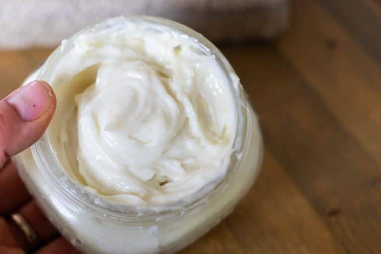 Scooping shaving cream out of the container with our fingertips.