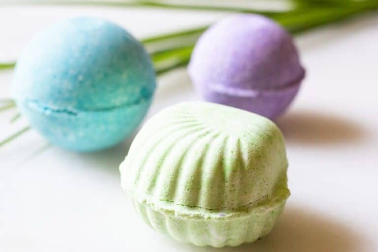 Green, blue, and purple tropical bath bombs shaped as a seashell.