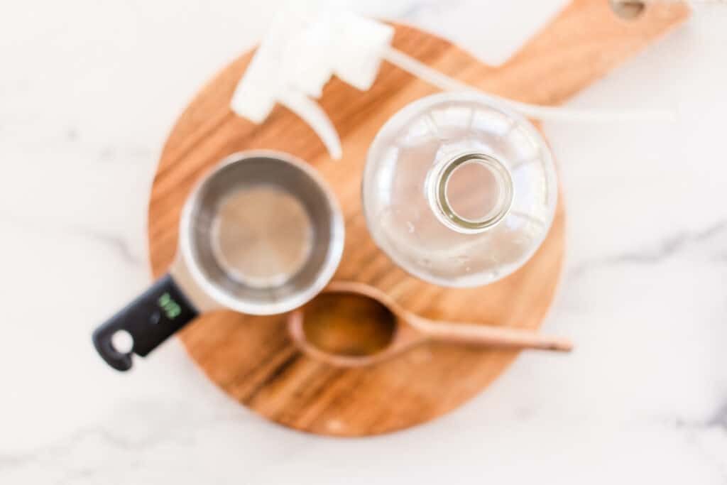 Wrinkle release spray ingredients for clothes on a wooden board.