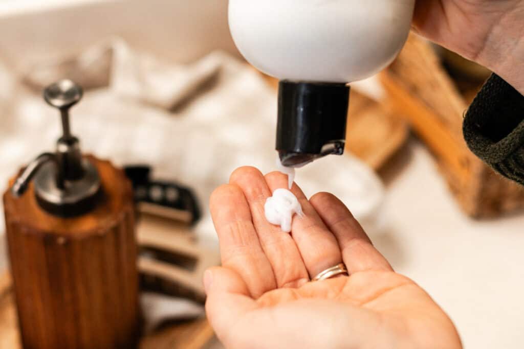 Getting a little bit of conditioner into the palm of our hand so we can mix it with the salt.