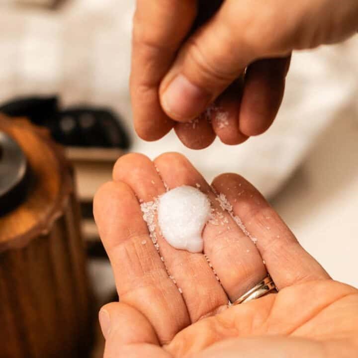 Spreading epsom salts onto our hair conditioner.