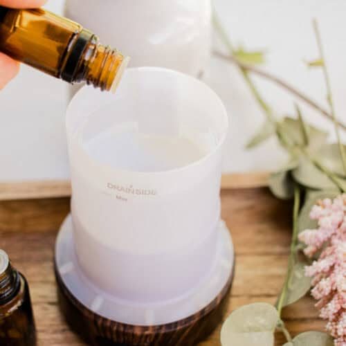 Adding different essential oils to the diffuser reservoir.