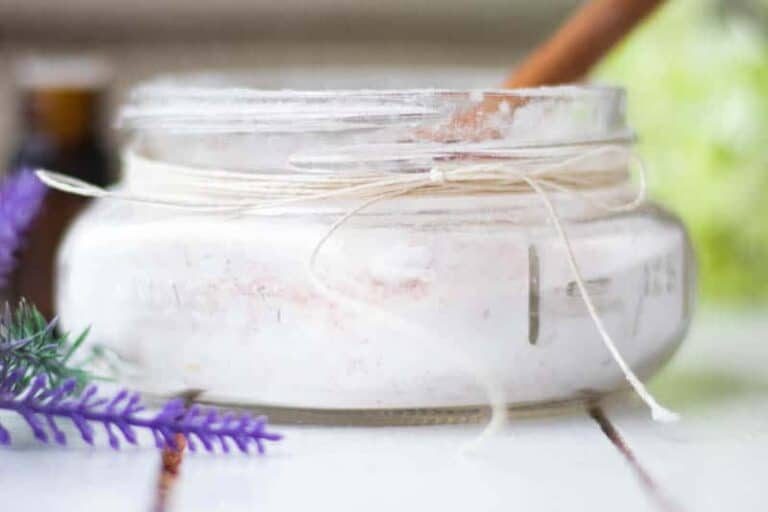 Decorative glass of bath salts with hemp and lavender sprigs.