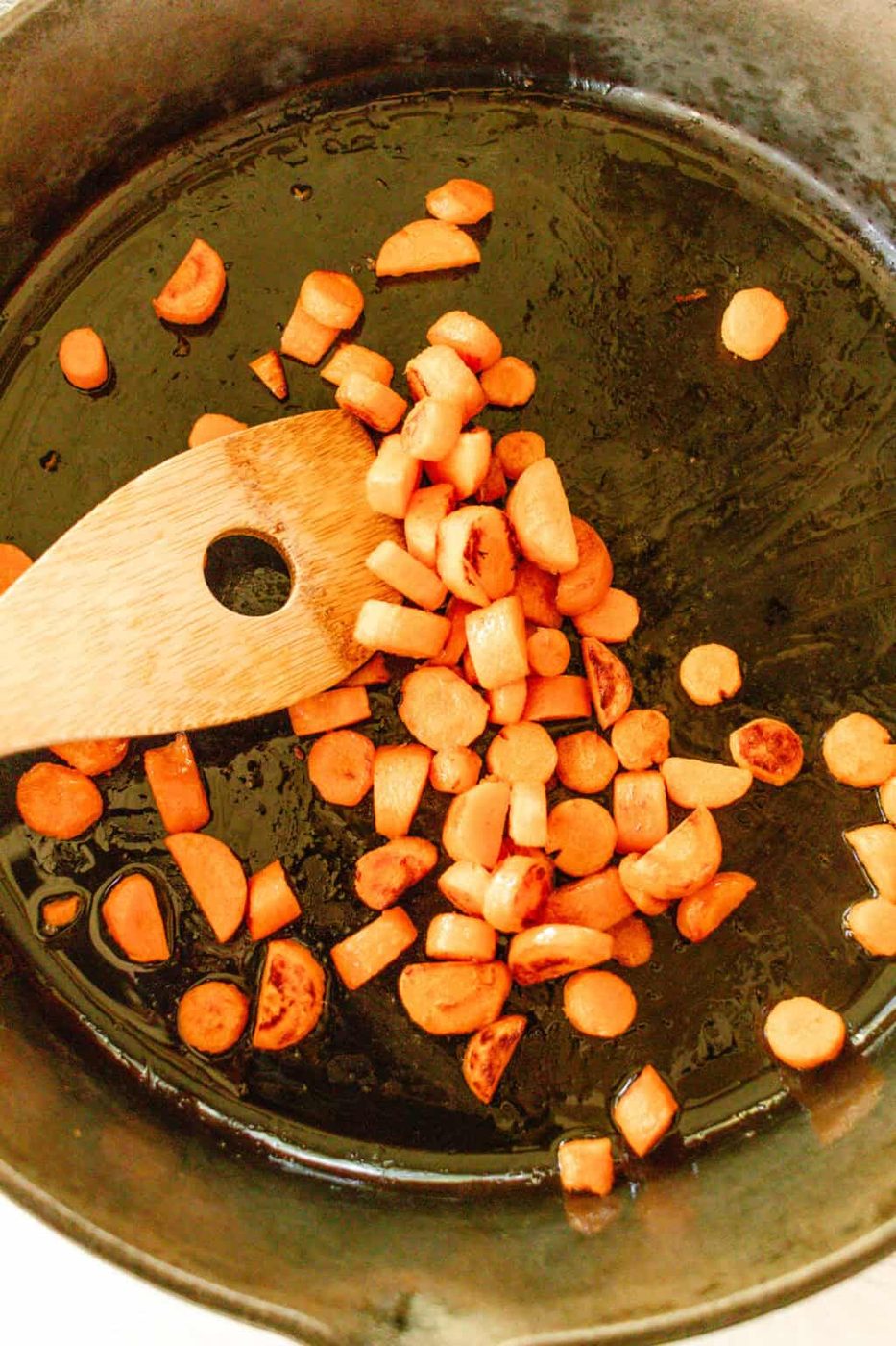Sauteing carrots in a cast iron skillet.
