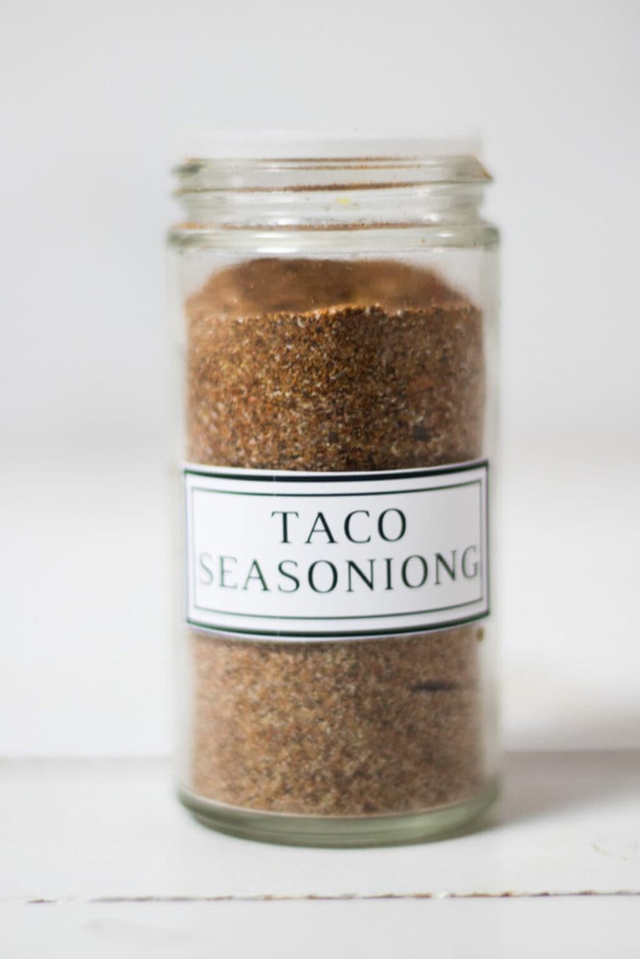 A labeled jar of taco seasoning.