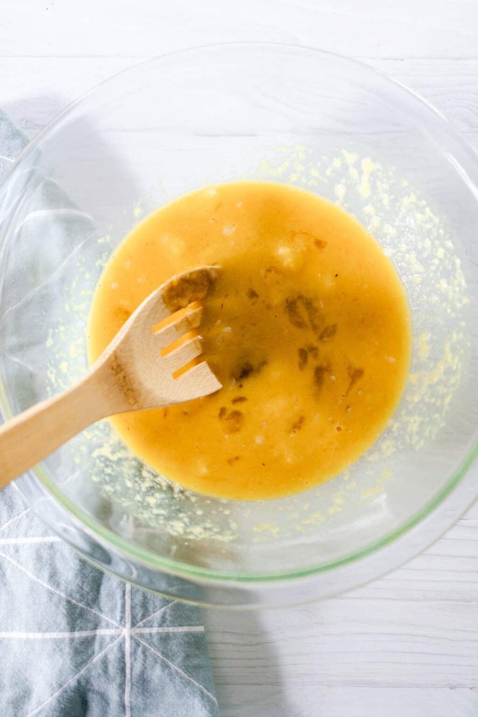 Stirring the wet ingredients together in a glass bowl.