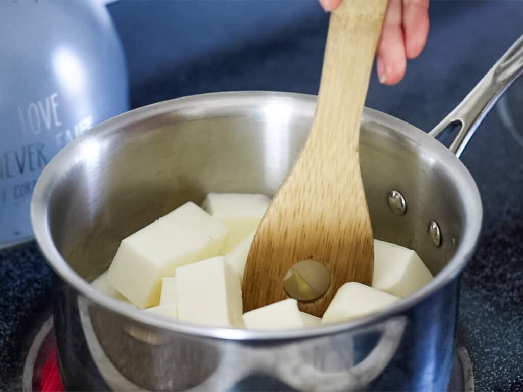 Melting cubes of goat milk soap base in a double boiler.