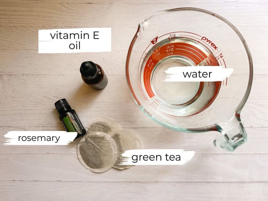 Green tea hair rinse ingredients labeled on a white table.