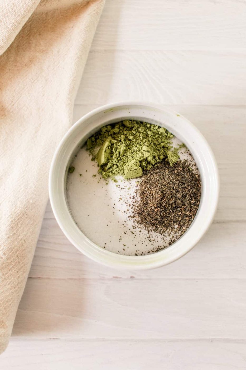 Dry ingredients for matcha scrub in a bowl.