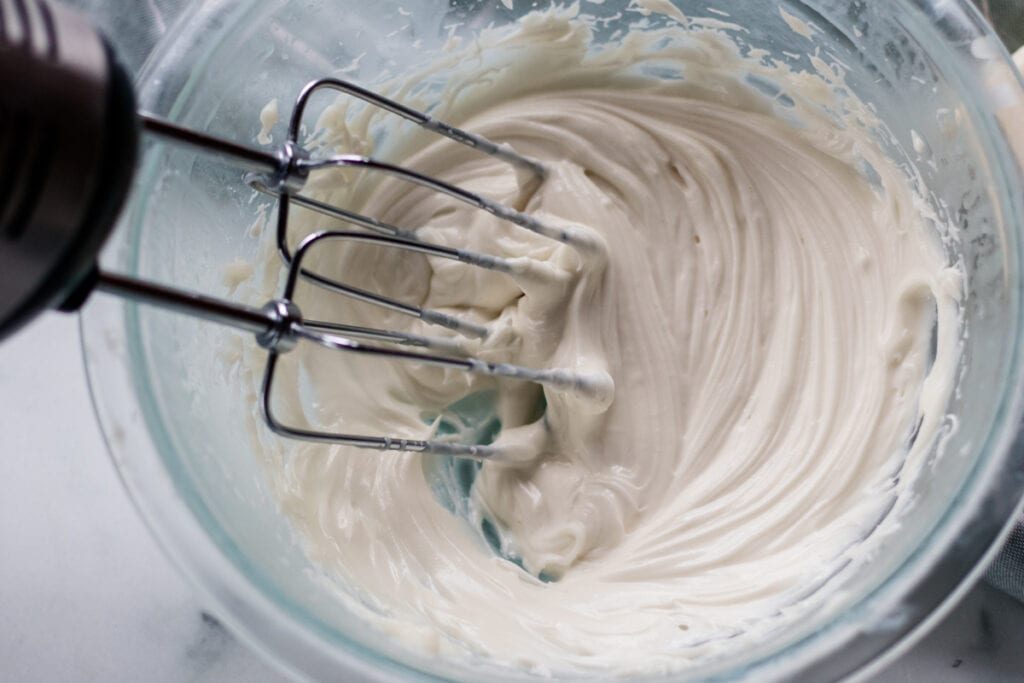 Whipping the hair butter with a hand mixer.