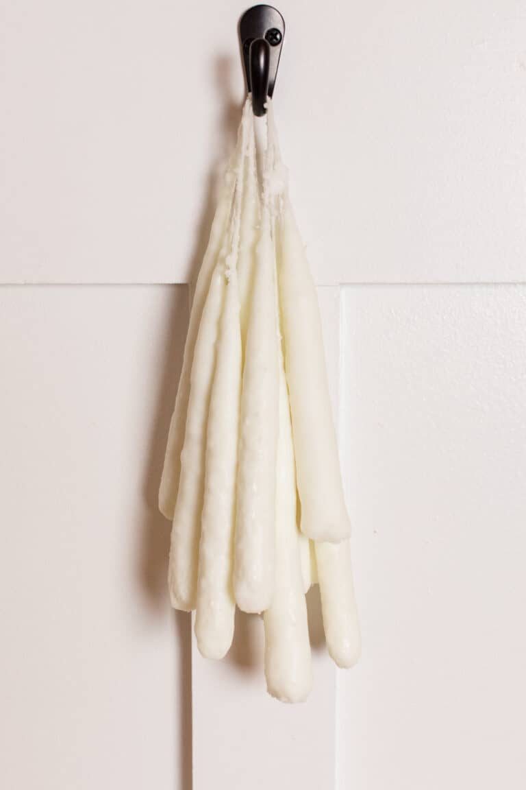 Hanging hand dipped candles to dry.