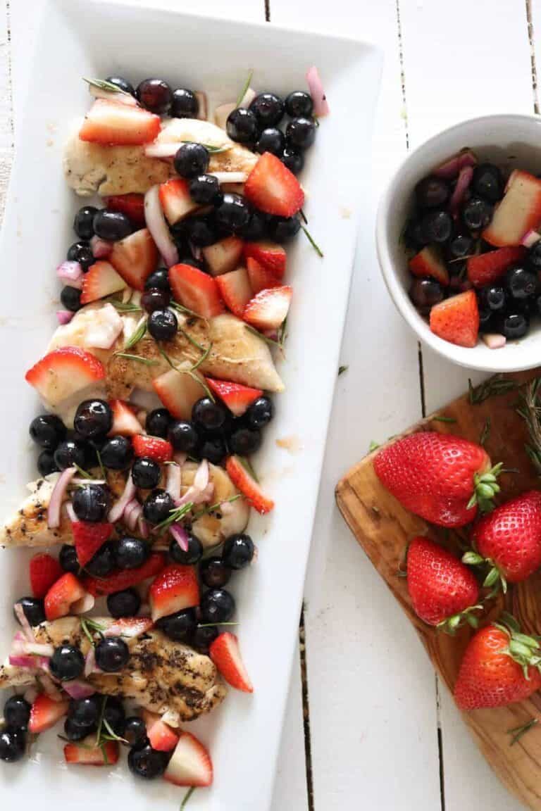 Berry balsamic chicken on white platter.