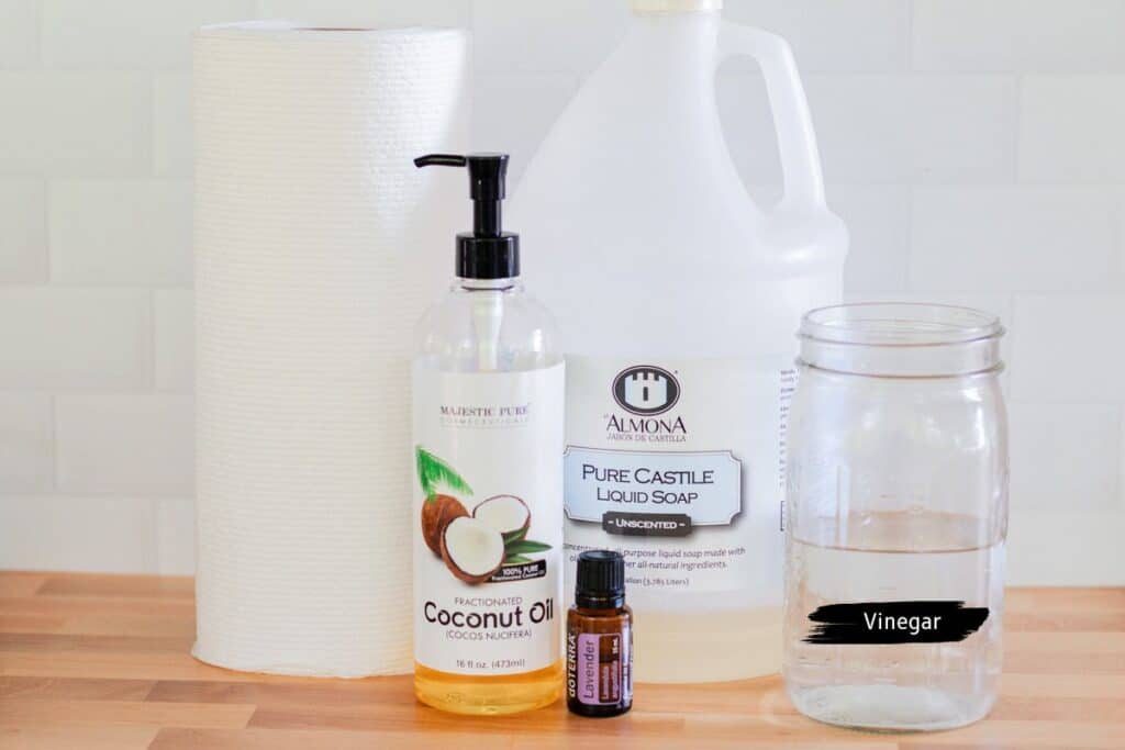 Homemade baby wipes ingredients assembled on a wooden countertop.