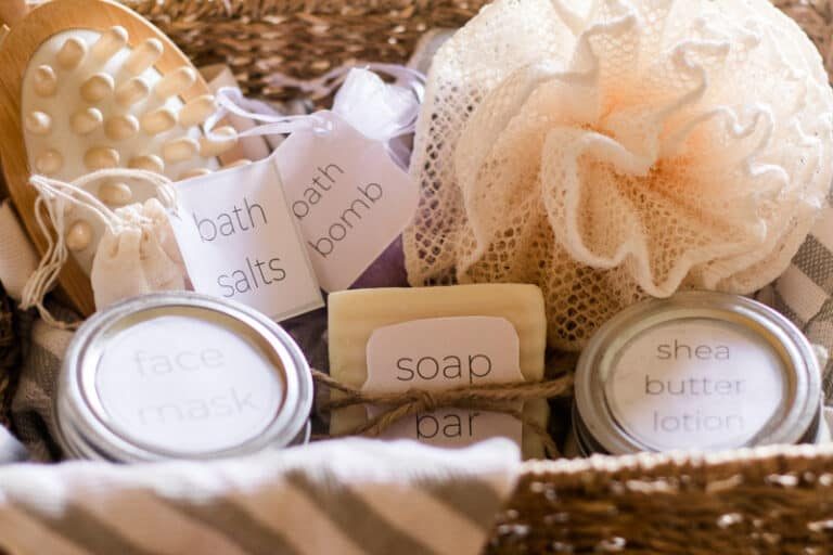 Basket with homemade bath bomb, bath salts, soap bar, and whipped body butter.