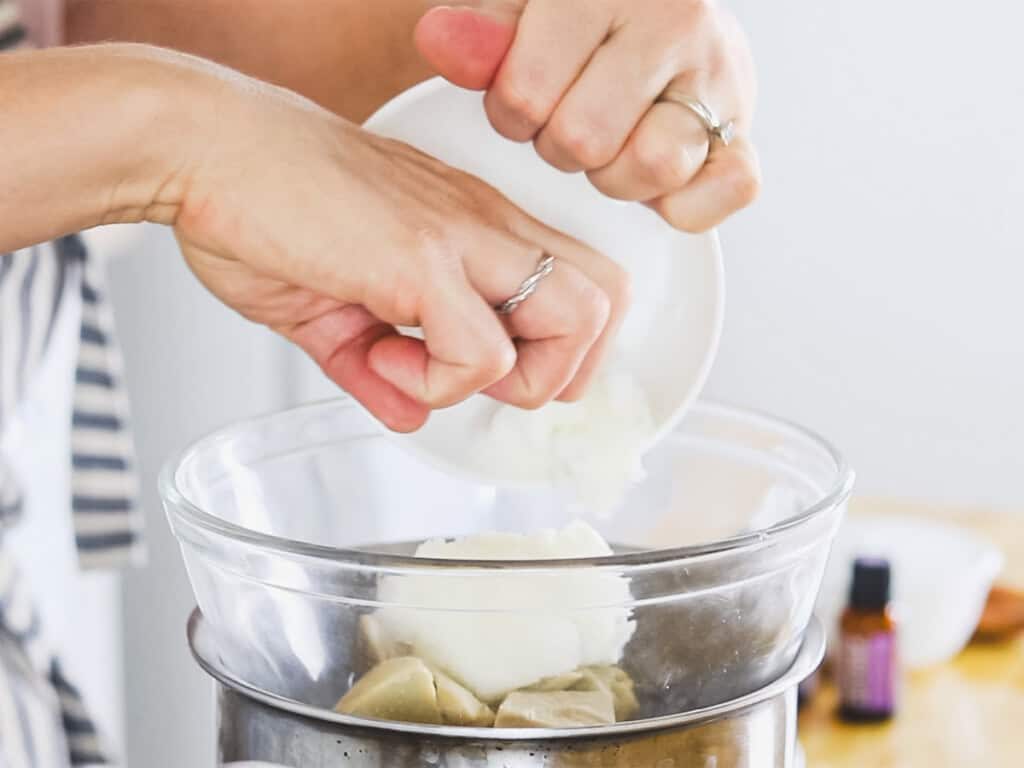 Putting homemade body butter ingredients in a double boiler.