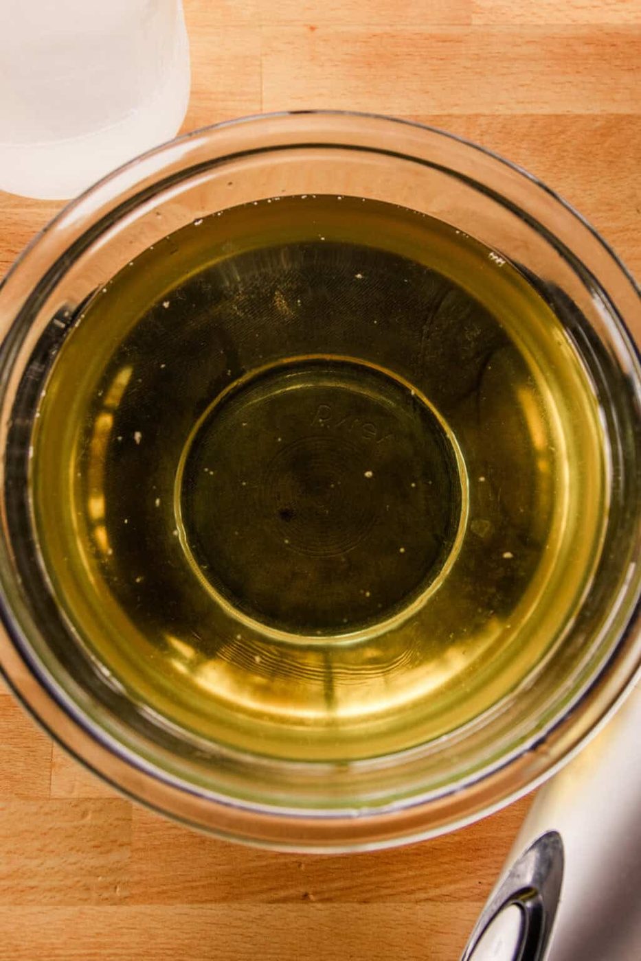 Melted oils and lard in a glass bowl.