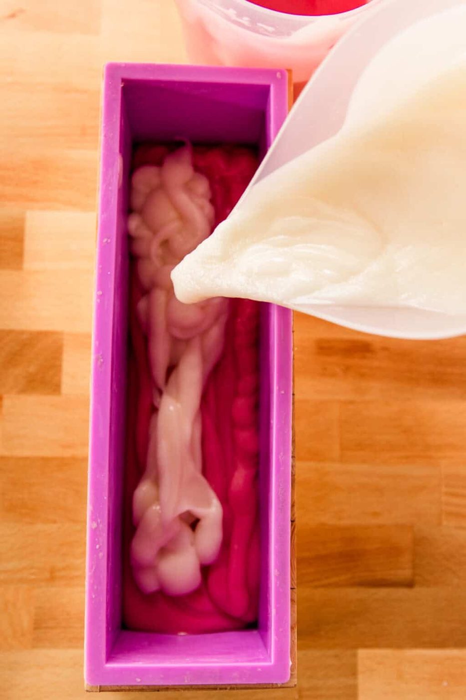 Pouring soap into silicone soap molds.