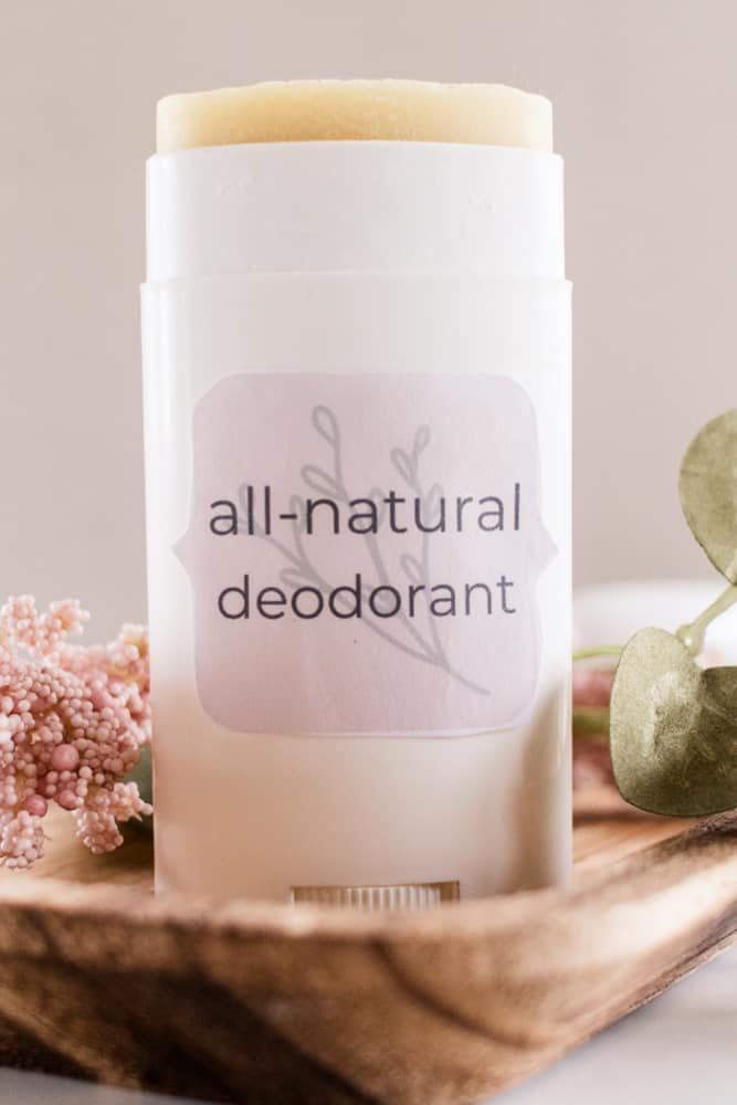 Homemade deodorant on wooden show board and fragrance flowers.