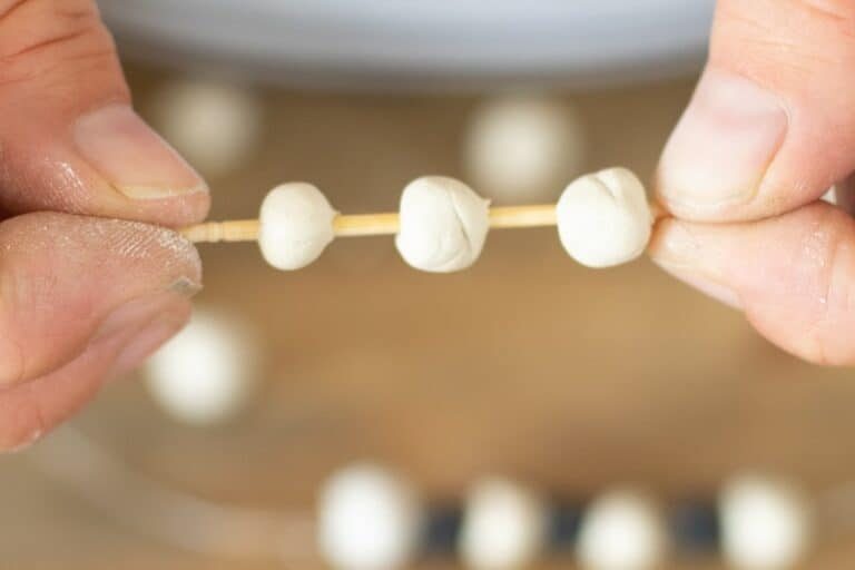 toothpick with clay beads on it