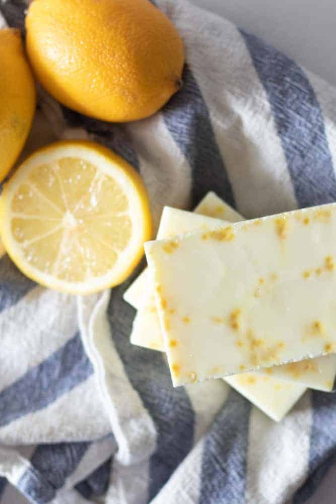 lemons and lemon dish soap bars on blue and white strip towel.