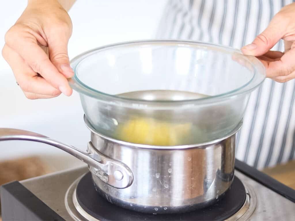 Melting ingredients for drawing salve in a glass bowl double boiler.