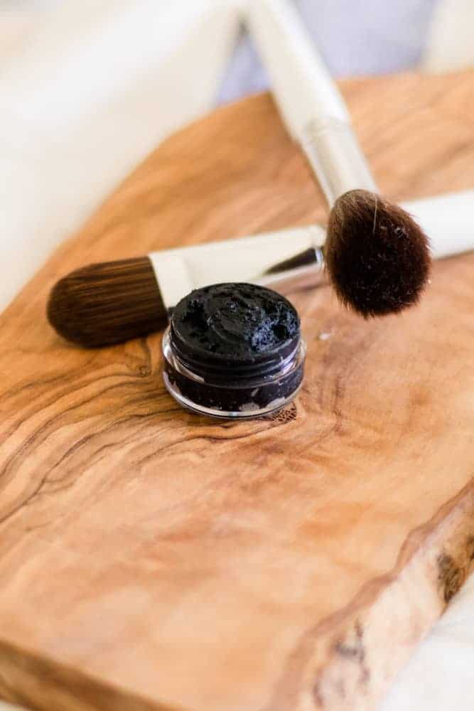 DIY eyeliner and applier on wooden top.