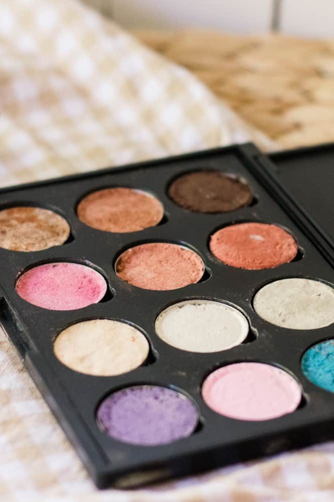 Colorful homemade eyeshadow in eyeshadow container.