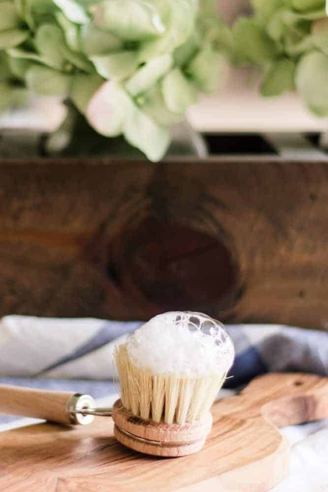 Homemade shaving cream on wood scrub brush.