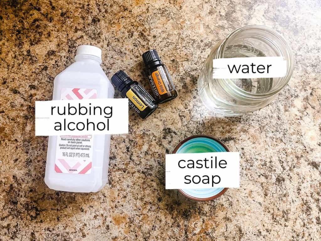 Homemade granite cleaner ingredients labeled on a kitchen countertop.