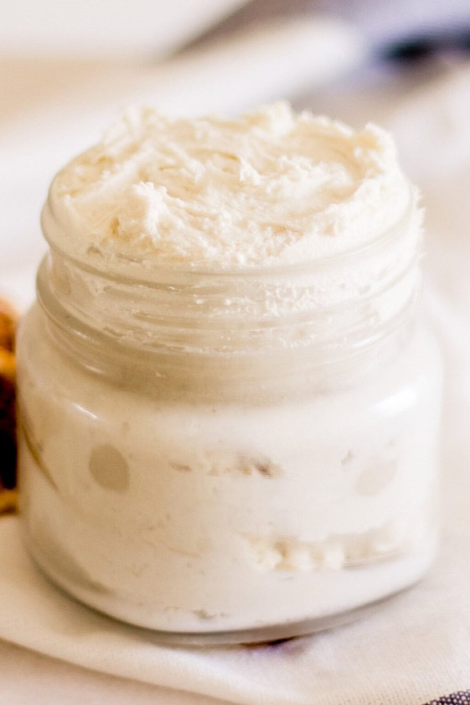 Homemade hand cream in a small glass jar.