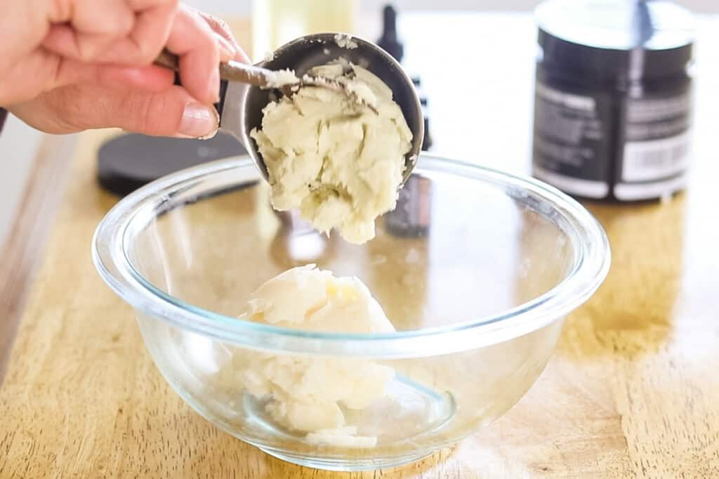 Adding the shea butter and mango butter to the double boiler.