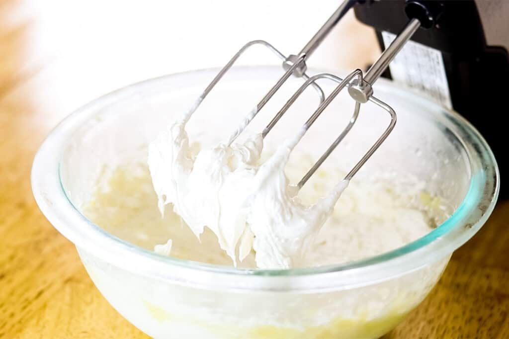The whipped hand cream, all light and airy on the end of a hand mixer overtop of the bowl.