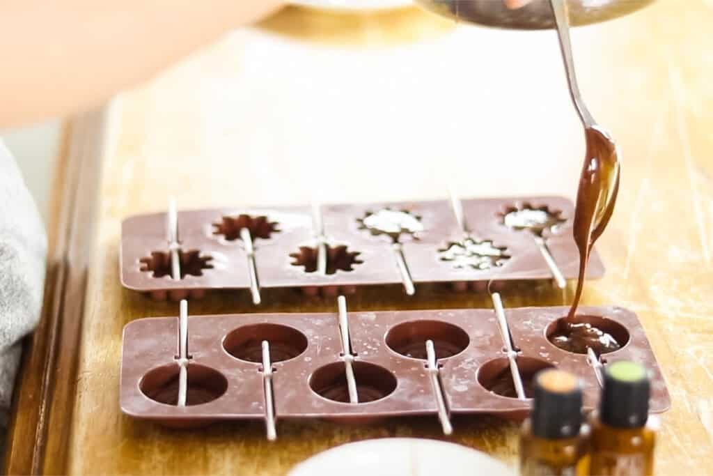Pouring lollipop mixture into molds.