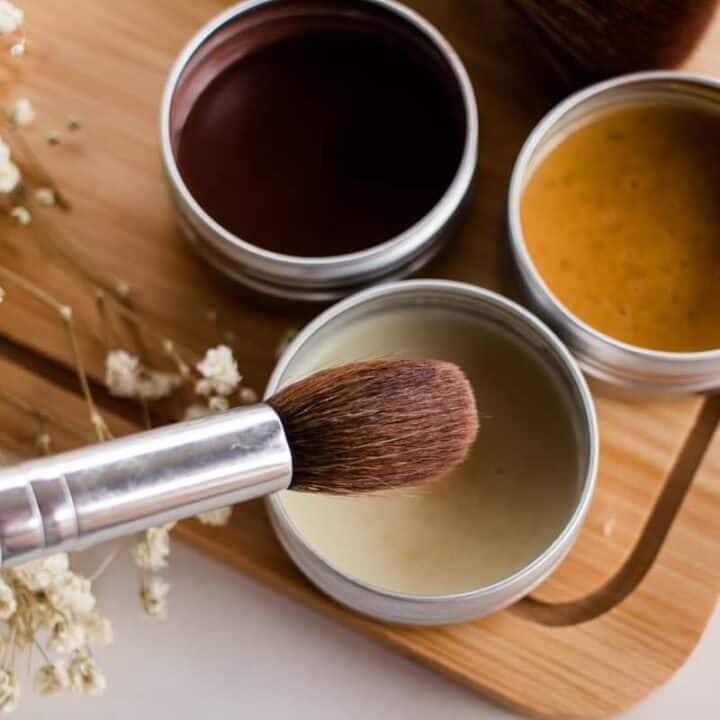 Dipping a makeup brush into a DIY highlighter recipe.