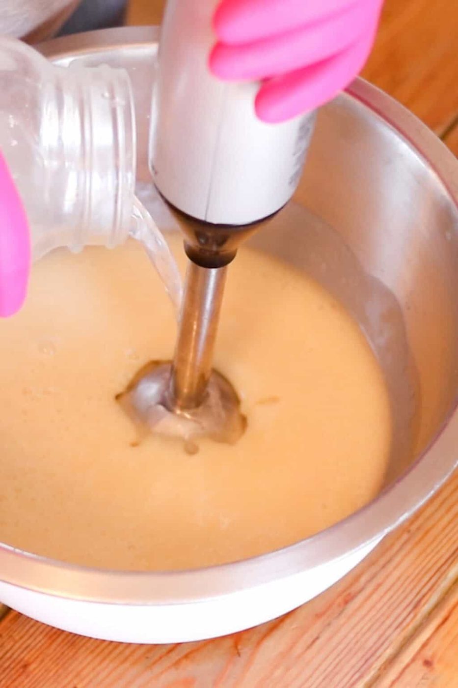 Mixing soap mixture with an immersion blender.