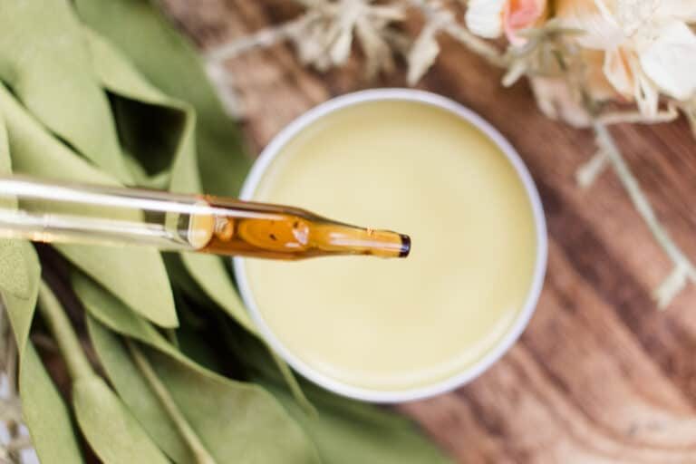 Lemon balm salve close up with dropper bottle.