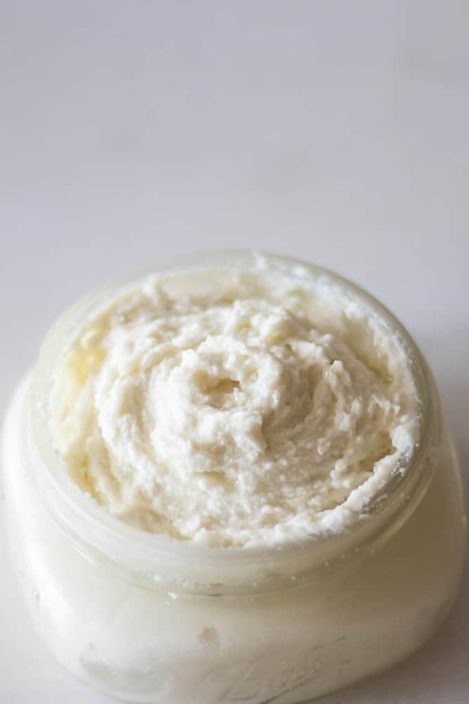whipped lotion in mason jar on white marble