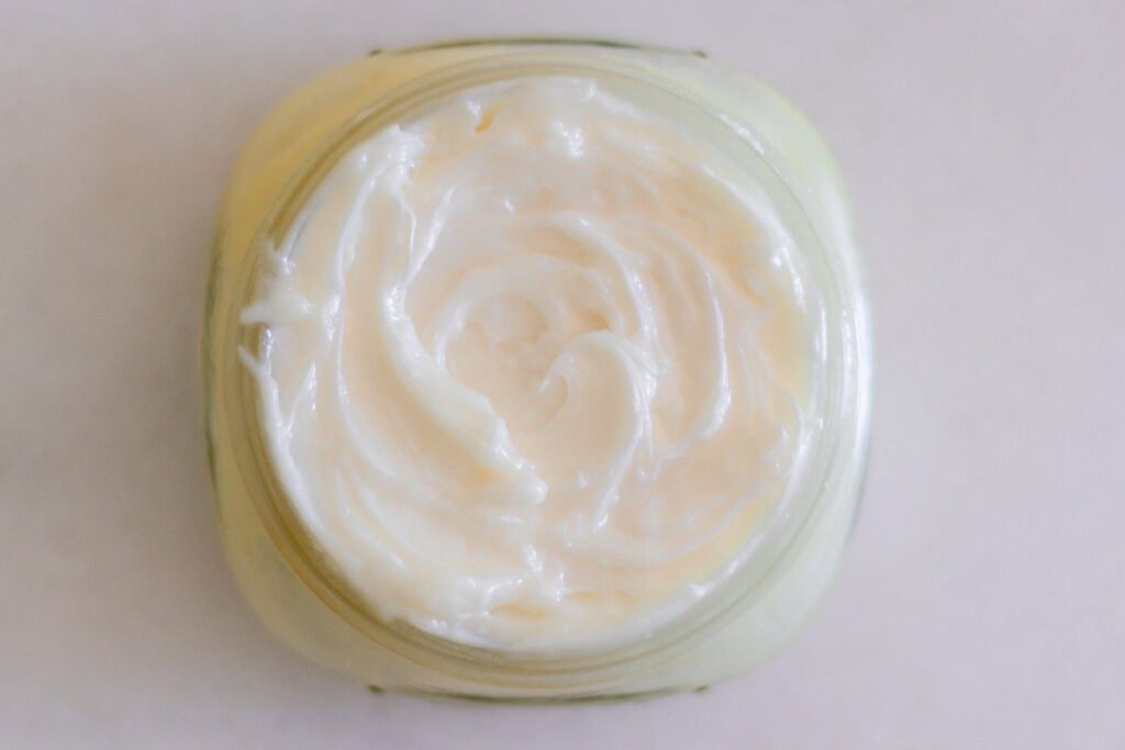 Looking down on a jar of whipped mango body butter.