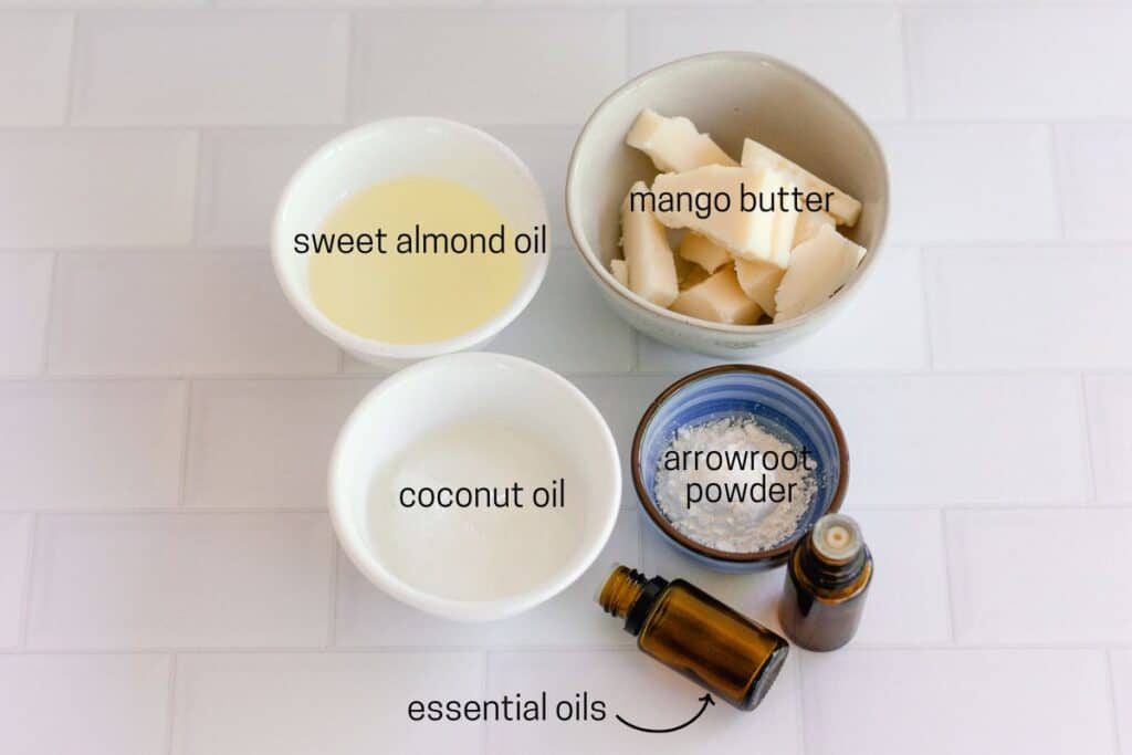 Whipped mango body butter ingredients on a white countertop.