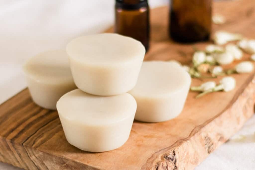 Muscle rub lotion bars on a wooden board.