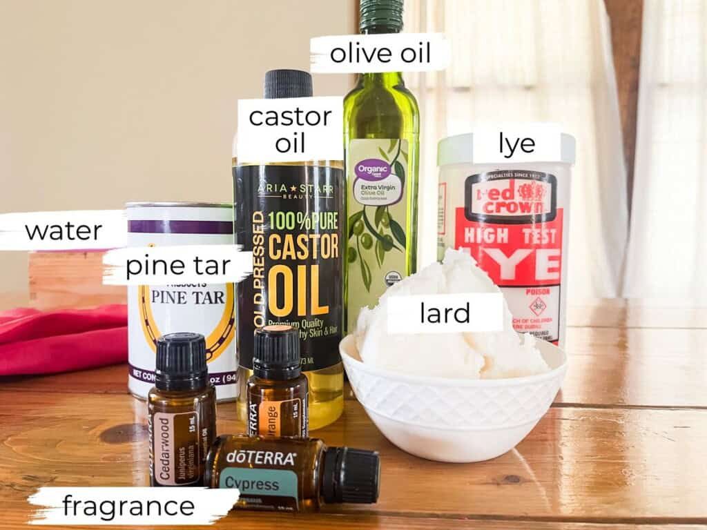 Pine tar soap ingredients labeled on a wooden table.