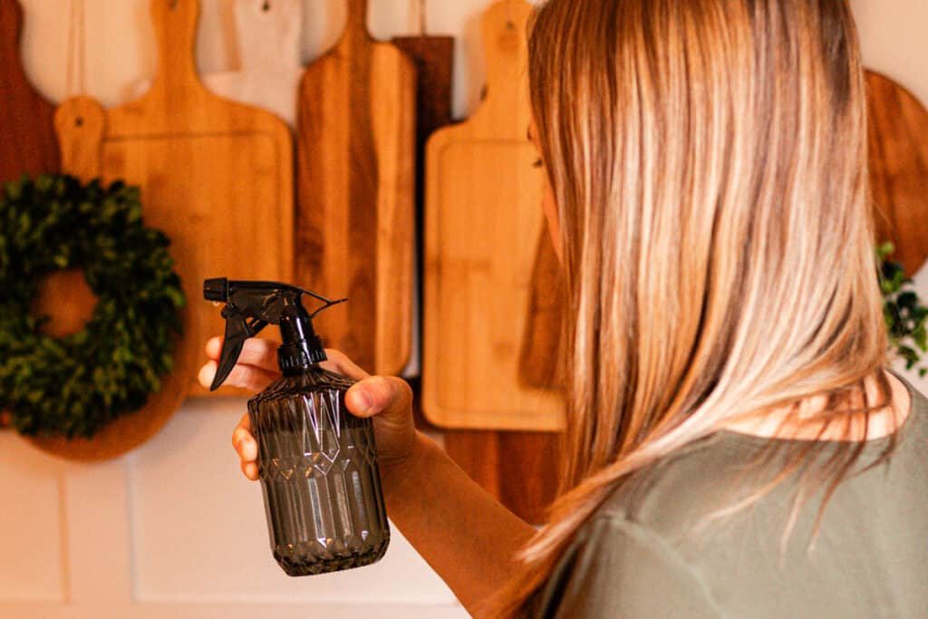 Spraying the walls of the dining room with our homemade room spray.